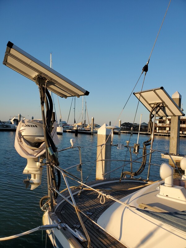 two pole mounted rigid marine solar panels on sailboat