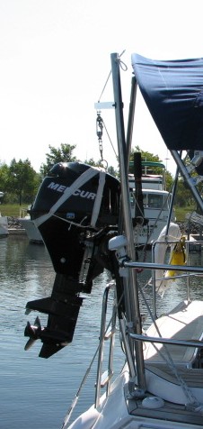 outboard motro lift crane on sailboat mounted to stern rail