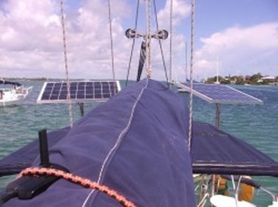 two rigid marine solar panels mounted on sailboar with top of pole mounting system