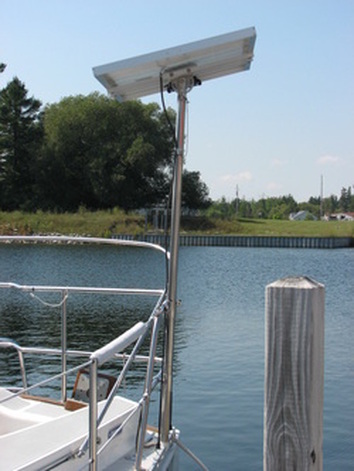 rigid marine solar panel mounted with adjustable top of pole mounting kit on boat