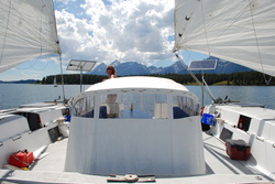 two rigid marine solar panels mounted top of pole on catamaran sailboat