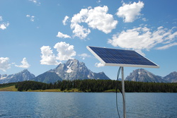 rigid marine solar panel mounted top of pole on sailboat with Teton mountains
