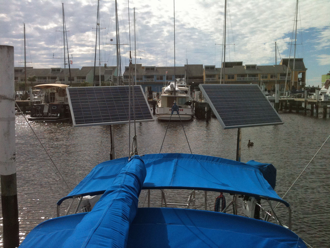 2 top of pole mounted marine rigid solar panels  on sailboat