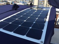 Flexible Marine solar panels mounted to a canvas bimini top on a sailboat