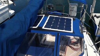 2 50 watt flexible marine solar panels mounted on bimini top of sailboat