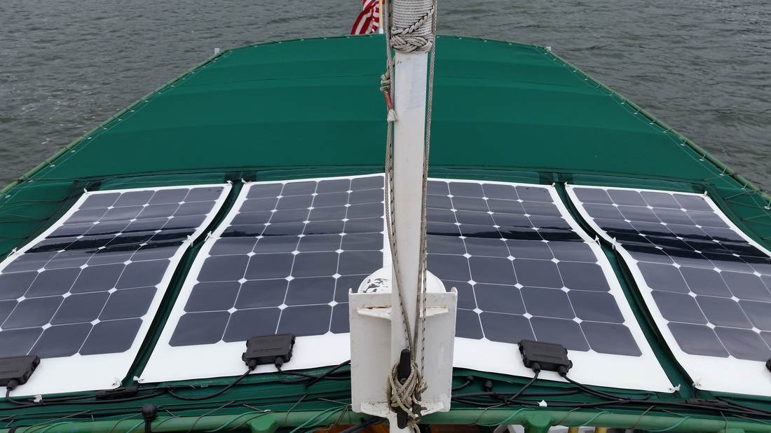 4 100 watt flexible marine solar panels mounted on bimini top on tugboat