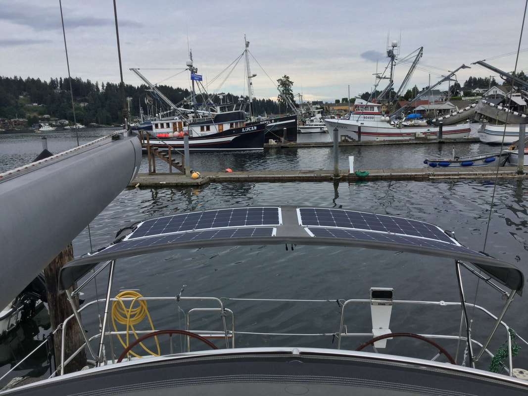 4 130 watt flexible marine solar panels mounted on a sailboat bimini