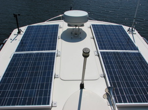 4 105 watt rigid marine solar panels mounted on roof of cruising nordic tug boat