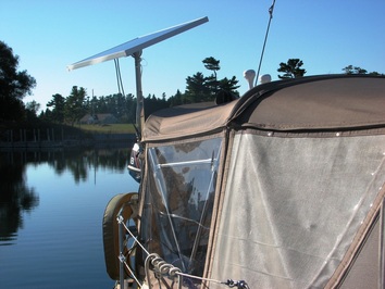 Rigid marine solar panel mounted top of pole on sailboat