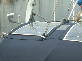 marine solar system kit with semi flexible marine solar panels mounted with bolts to bimini canvas on sailboat