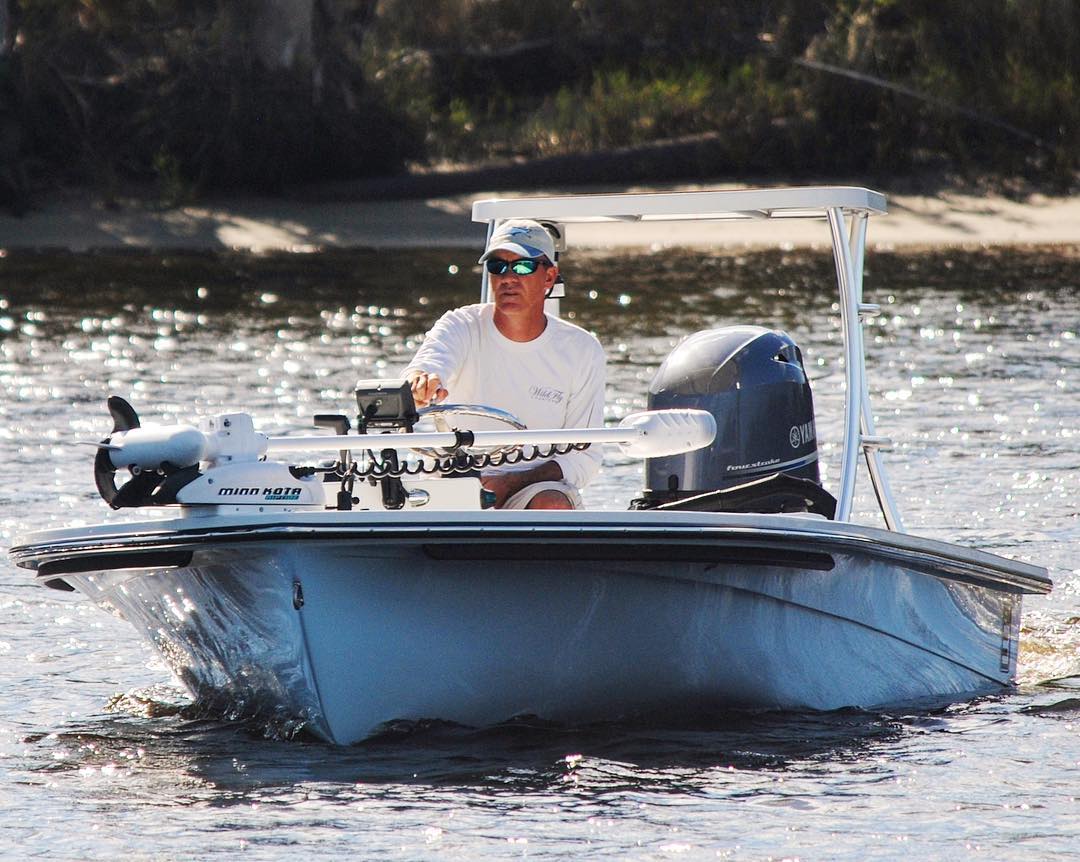 fisherman on a skiff with trolling motor and power pole