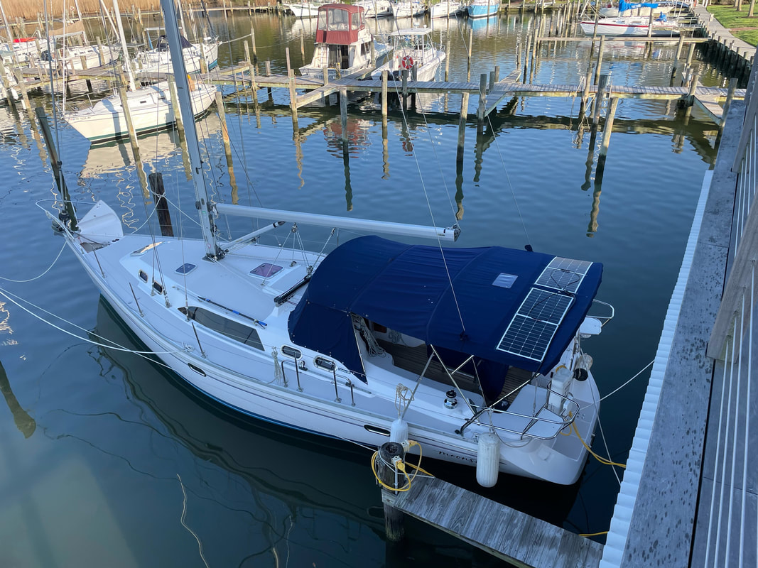 two 110 watt flexible marine solar panels mounted via bolting solar mount kit to bimini canvas on sailboat