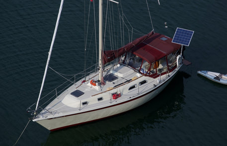 150 watt rigid marine solar panel mounted top of pole on Ericson 38 sailboat