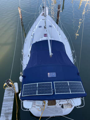 Two 110 Watt Semi-flexible Marine Solar Panels Installed Using the Bolt on kit Method to canvas on boat